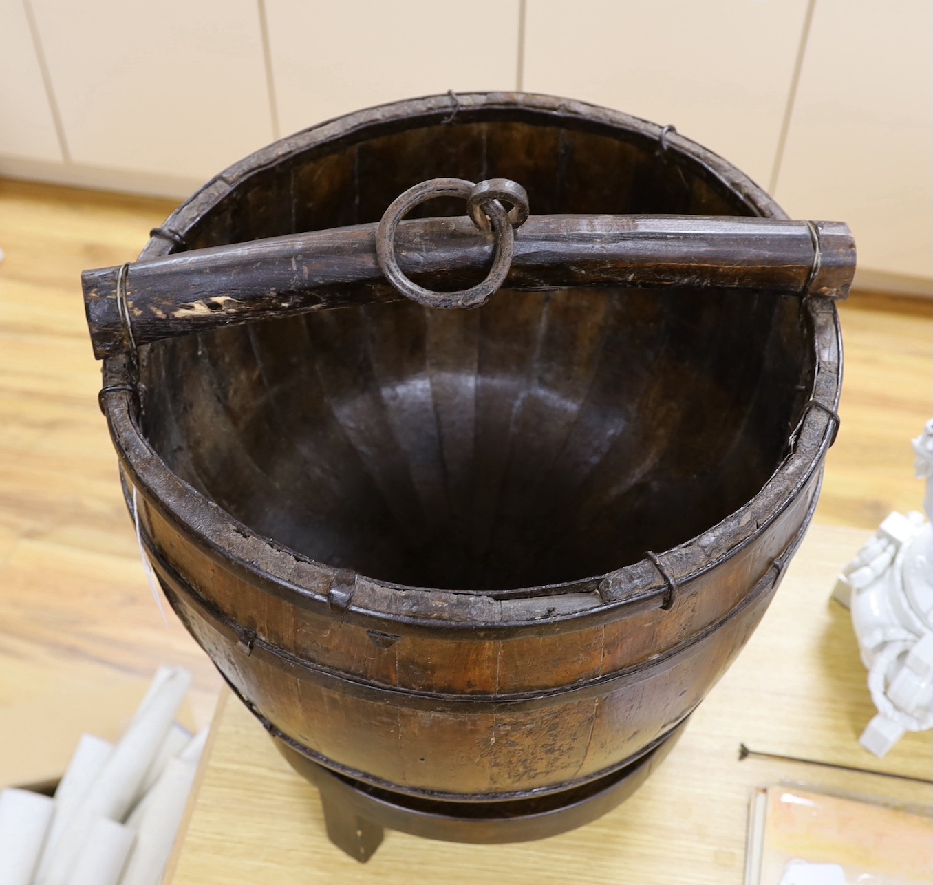 A Chinese wooden water bucket and carrying handle on stand, 55cms including stand